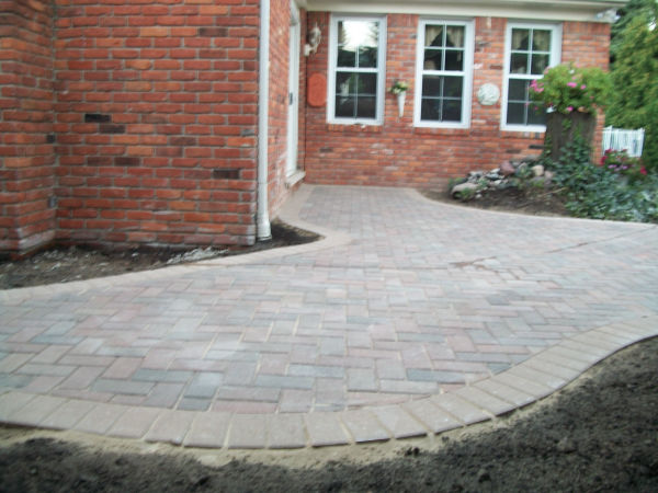 Brick Paver Patio and Stone Retaining Wall Side View Brick Paver Patio and Stone Retaining Wall Side View