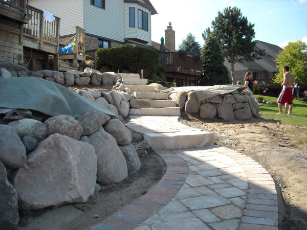 Stone Retaining Wall and Brick Paver Walkway Stone Retaining Wall and Brick Paver Walkway